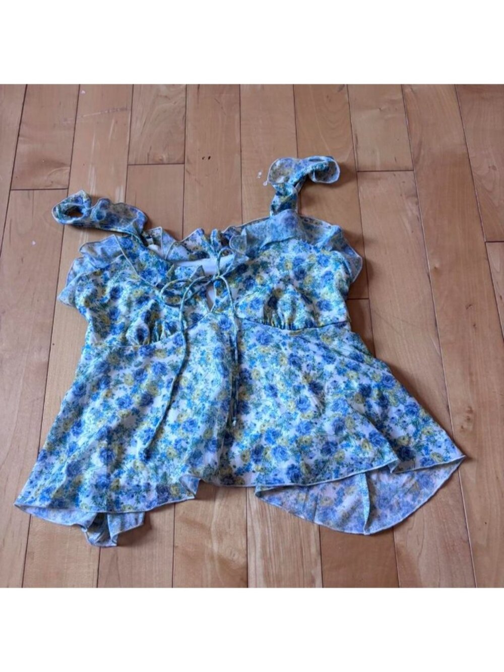 Blue and yellow floral babydoll top with ruffles and tie detail